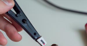 Using a laser to clean the connections of a battery before connecting them together.